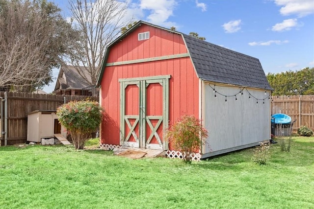 view of shed featuring fence