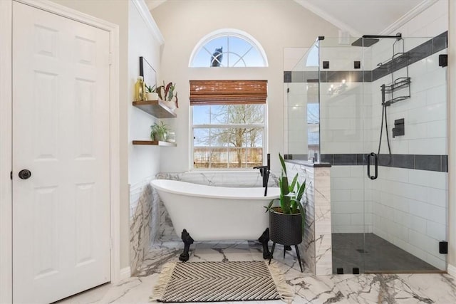 bathroom with a soaking tub, marble finish floor, vaulted ceiling, crown molding, and a shower stall