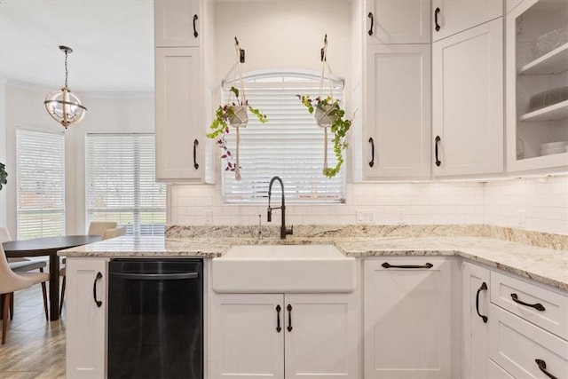 kitchen with a sink, crown molding, white cabinetry, and dishwasher