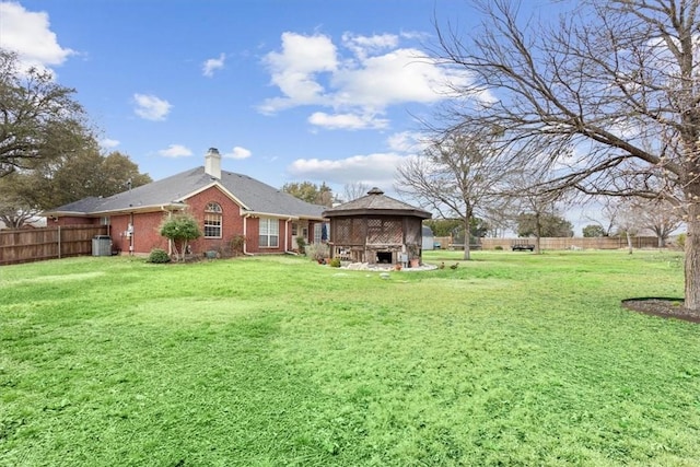 view of yard featuring a gazebo, central AC, and fence