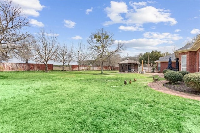 view of yard with fence and a gazebo