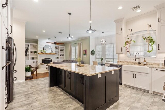 kitchen featuring stainless steel appliances, a sink, visible vents, and white cabinetry