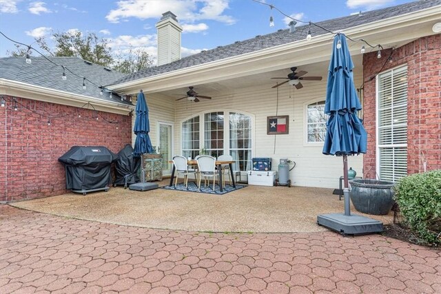 exterior space featuring a grill and a ceiling fan