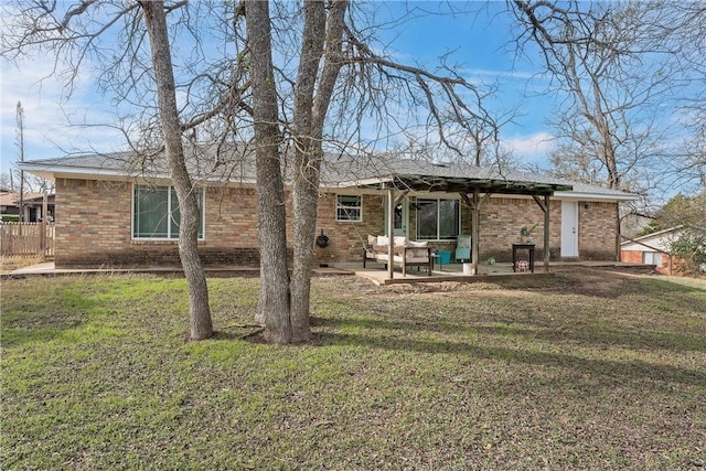 back of property with a patio and a yard