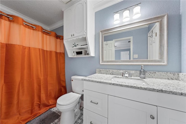 bathroom with a textured ceiling, toilet, ornamental molding, and vanity