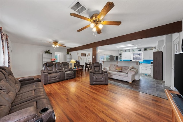 living room featuring dark wood-type flooring and ceiling fan