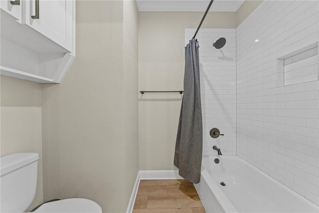 bathroom with shower / bathtub combination with curtain, wood-type flooring, and toilet