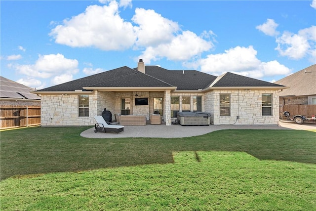 rear view of property featuring an outdoor hangout area, a hot tub, a patio area, and a lawn