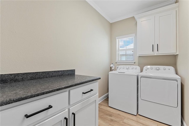 laundry room with washer and dryer, cabinets, ornamental molding, and light hardwood / wood-style flooring