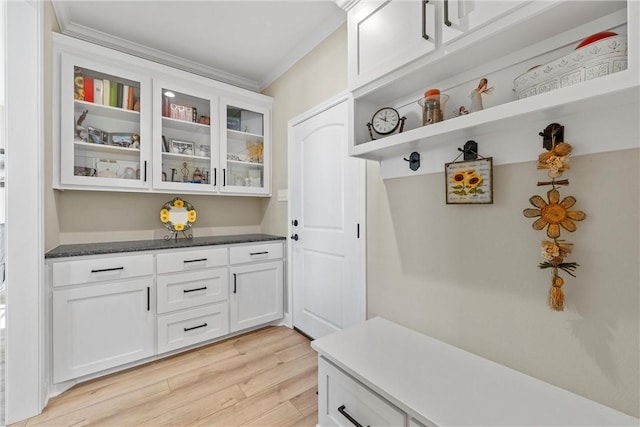 mudroom featuring light wood-type flooring and ornamental molding