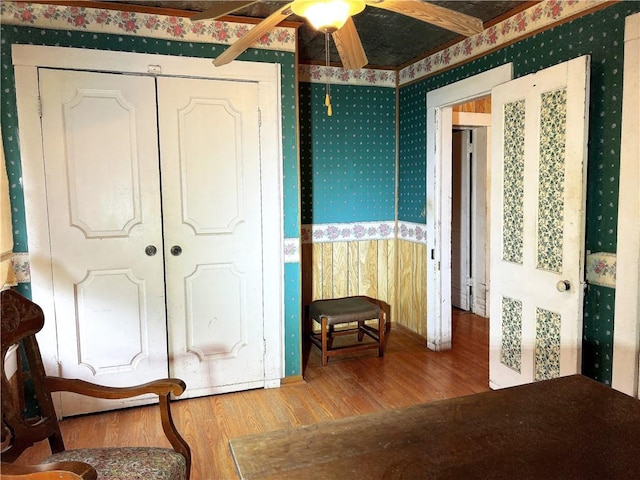 bedroom with ceiling fan, a closet, and wood-type flooring