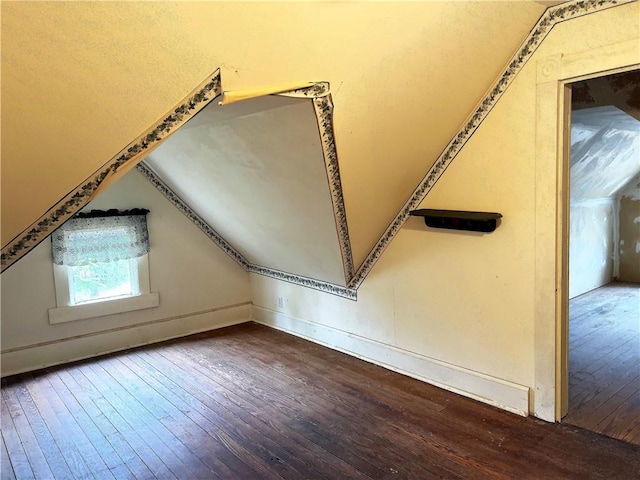 bonus room featuring hardwood / wood-style floors and lofted ceiling