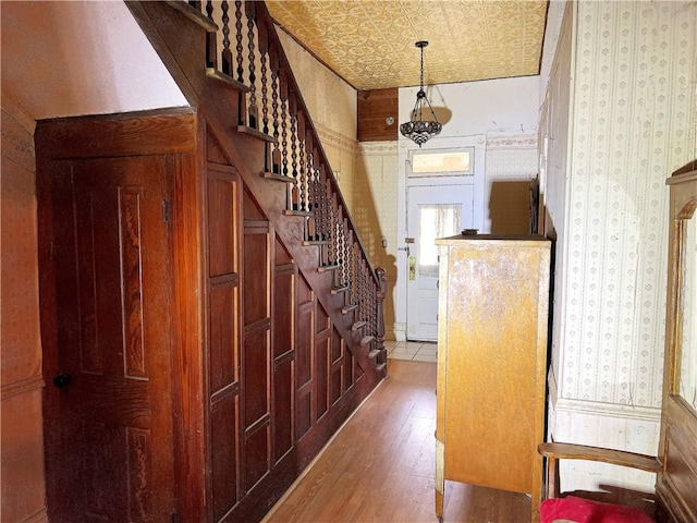 interior space featuring hardwood / wood-style flooring and an inviting chandelier