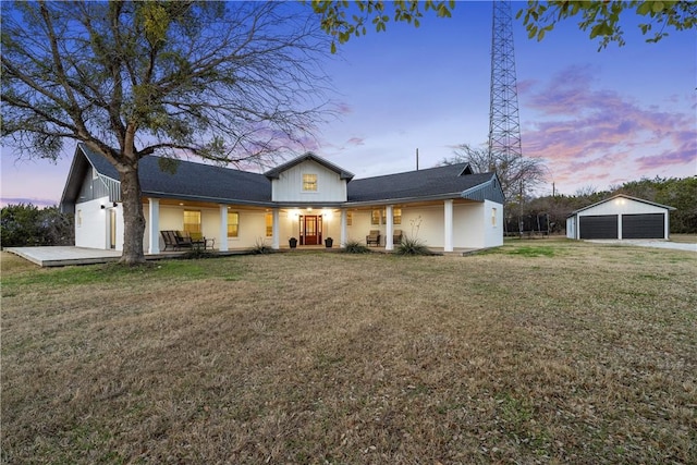 view of front of property with a garage and a lawn