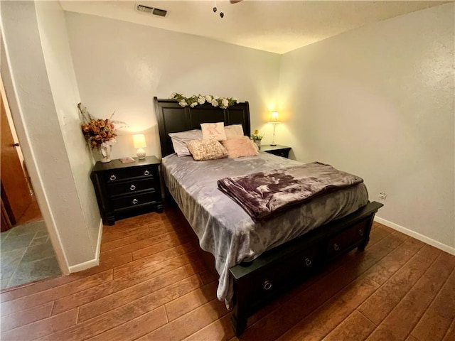 bedroom with dark hardwood / wood-style floors