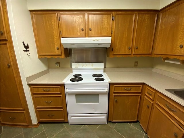 kitchen with dark tile patterned floors and white electric range