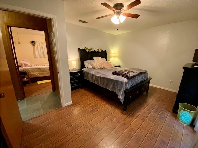 bedroom featuring ceiling fan and dark wood-type flooring