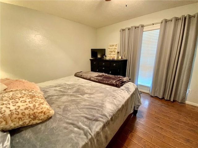 bedroom featuring ceiling fan and dark wood-type flooring