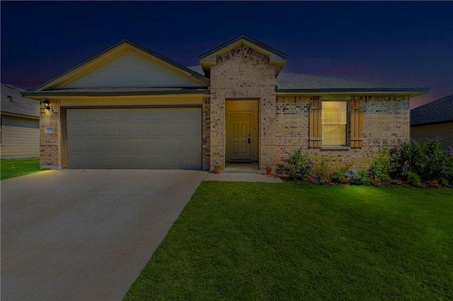 view of front of property with a yard and a garage