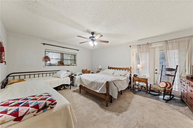 bedroom featuring carpet flooring, a textured ceiling, access to outside, and ceiling fan