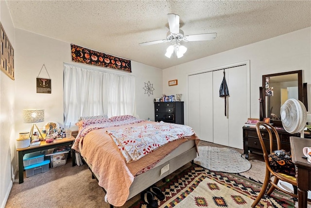 bedroom featuring carpet, a textured ceiling, a closet, and ceiling fan