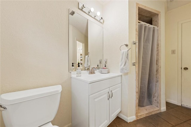 bathroom featuring a shower with curtain, vanity, toilet, and tile patterned floors