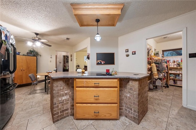 kitchen featuring pendant lighting, ceiling fan, black electric cooktop, and a textured ceiling