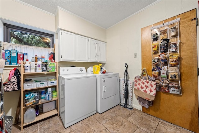 clothes washing area with cabinets, independent washer and dryer, a textured ceiling, and ornamental molding