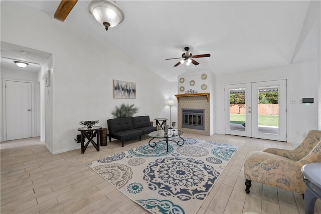 living room with french doors, ceiling fan, and vaulted ceiling with beams