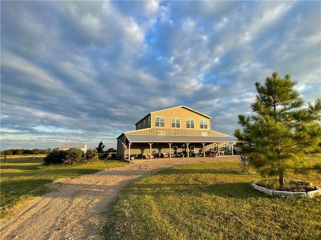 view of front of home with a carport and a front yard