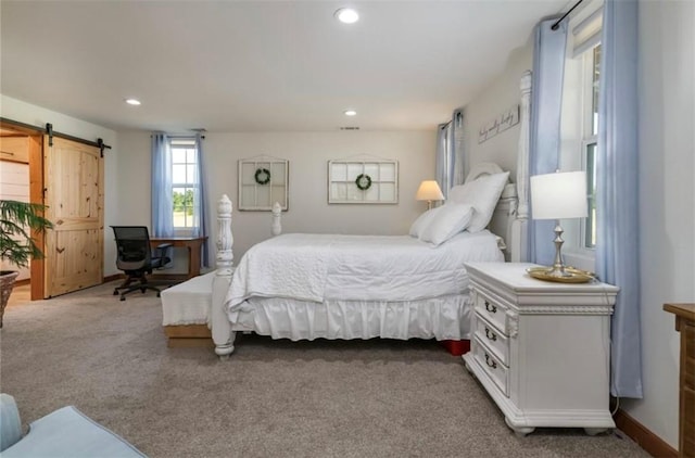 bedroom featuring carpet flooring and a barn door