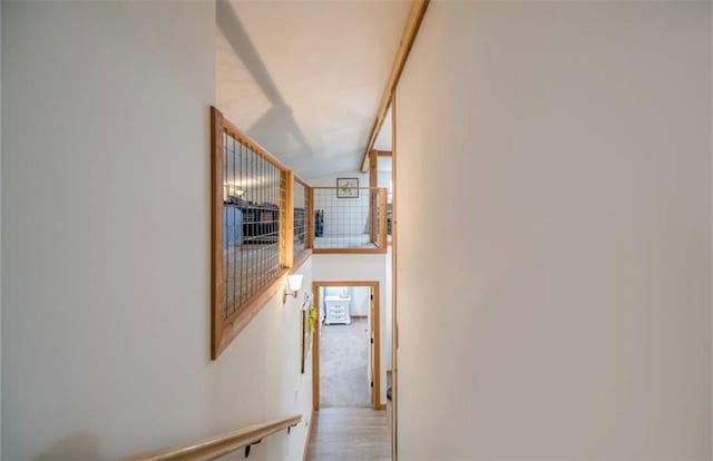 corridor featuring light hardwood / wood-style floors and lofted ceiling