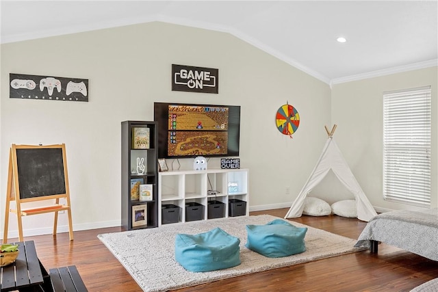 interior space featuring hardwood / wood-style floors, vaulted ceiling, and ornamental molding