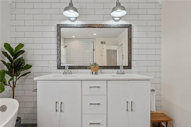 bathroom with vanity, crown molding, a tub to relax in, and tile walls