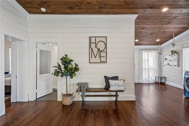 sitting room with wood walls, dark wood-type flooring, and wood ceiling