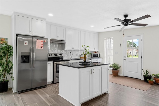 kitchen featuring white cabinets, light wood-type flooring, and appliances with stainless steel finishes