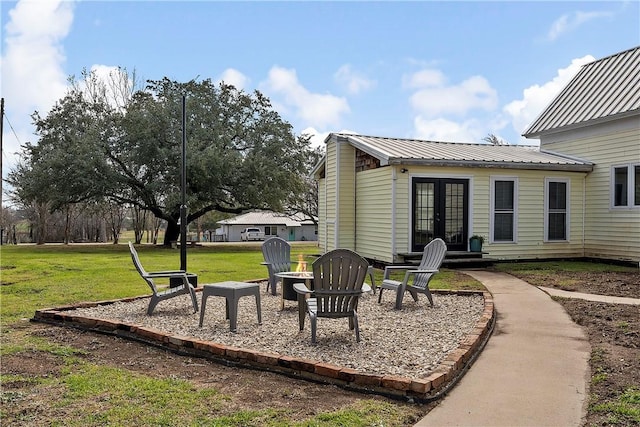 view of yard featuring french doors and an outdoor fire pit