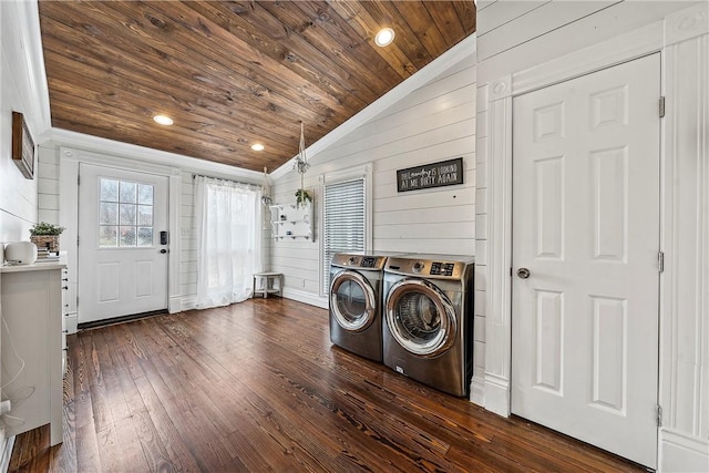 laundry area with independent washer and dryer, dark hardwood / wood-style flooring, wooden ceiling, and wood walls