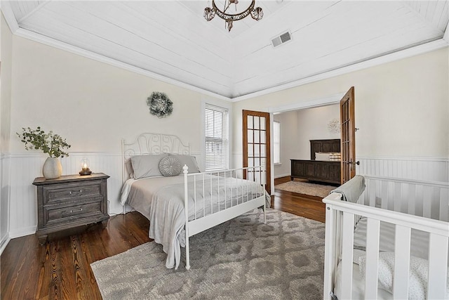 bedroom with dark hardwood / wood-style floors and crown molding