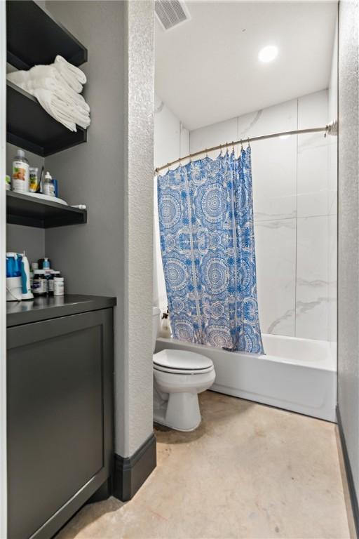 bathroom with shower / tub combo and toilet