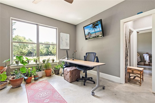 home office featuring concrete flooring