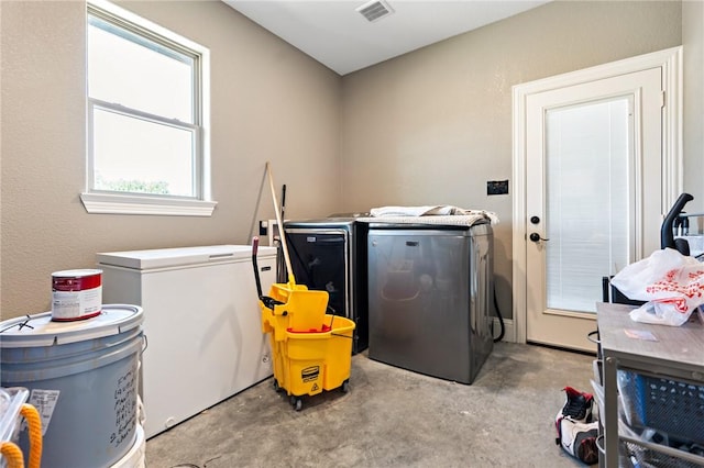 clothes washing area with washing machine and clothes dryer