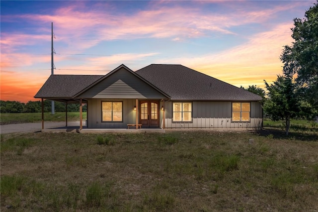 single story home featuring a lawn and a porch