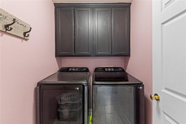 laundry area featuring cabinets and washing machine and dryer