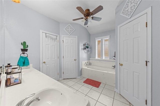 bathroom with tile patterned flooring, vaulted ceiling, a bathtub, and ceiling fan