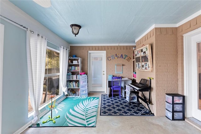 office space with brick wall and concrete floors