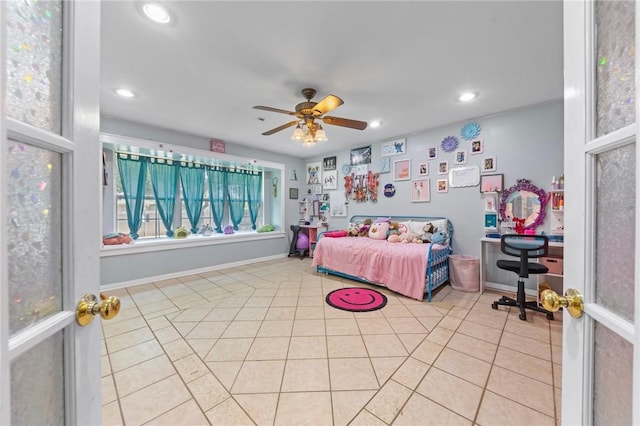 tiled bedroom featuring ceiling fan