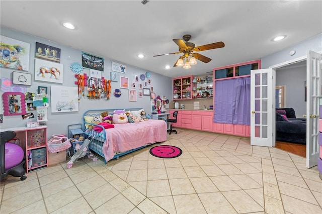 tiled bedroom with ceiling fan and french doors