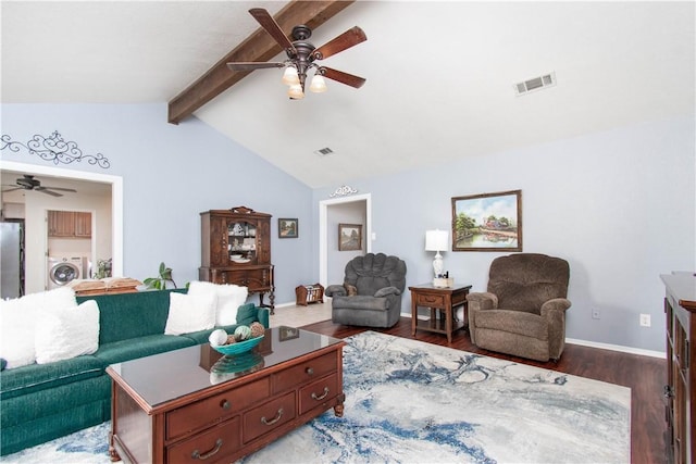 living area featuring vaulted ceiling with beams, washer / dryer, visible vents, and wood finished floors