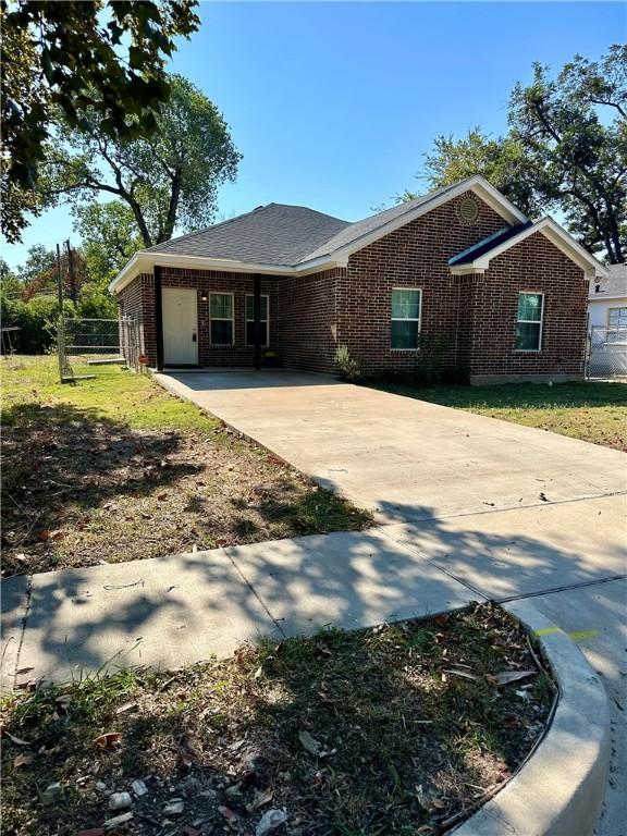 ranch-style house with a carport and a front lawn